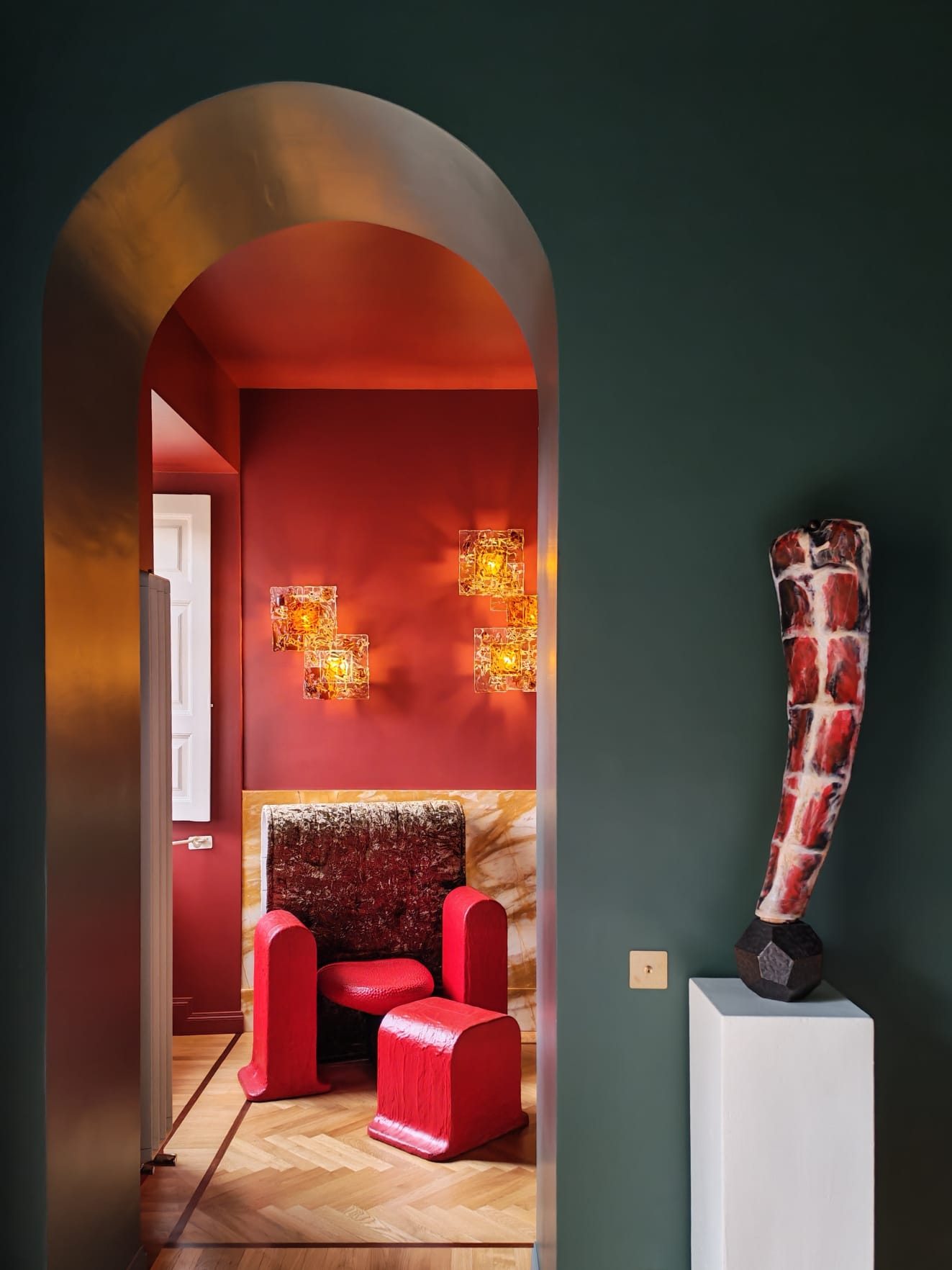 Red armchair beyond the arch
