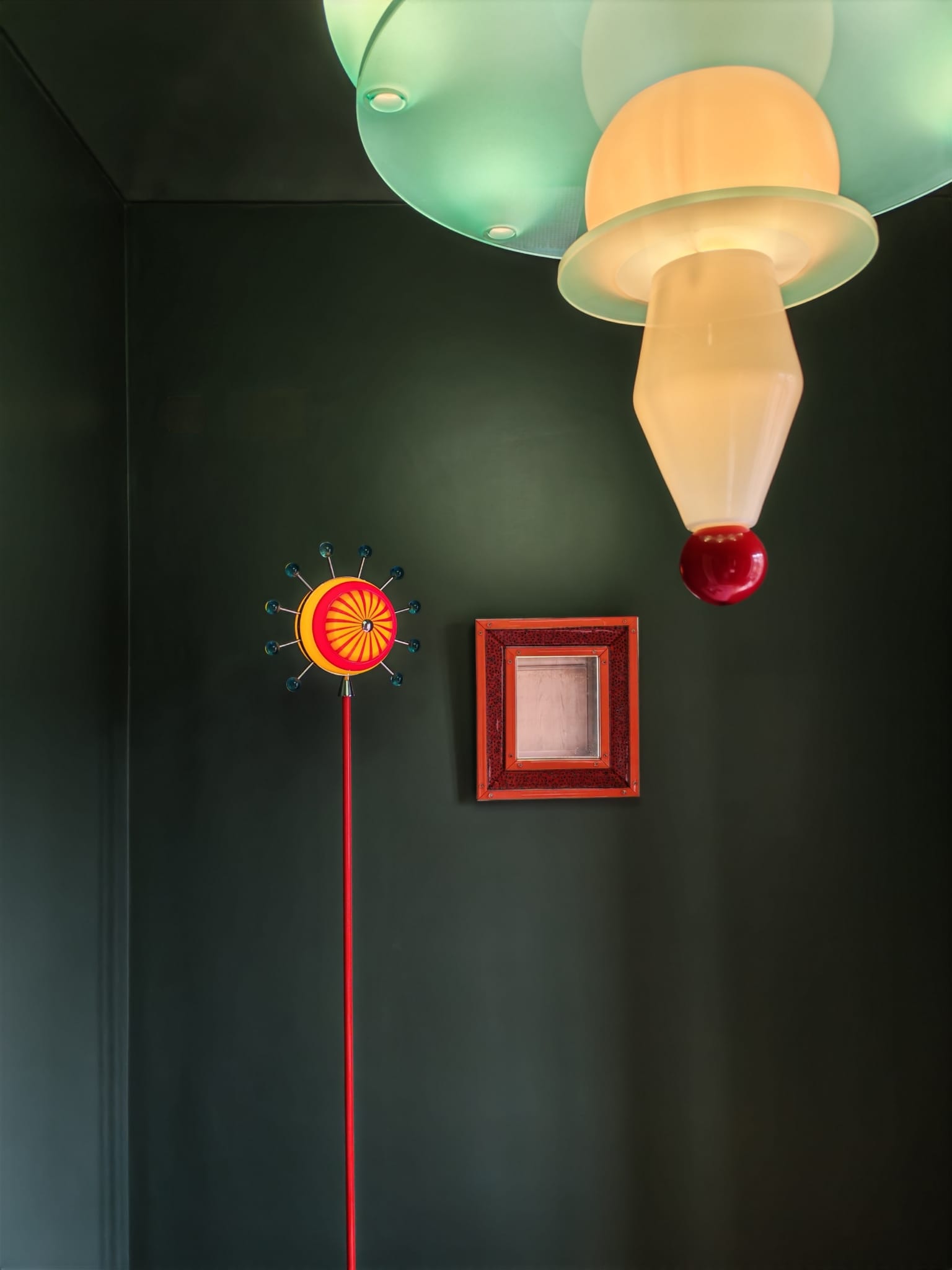 Mirror and lamp on a green wall